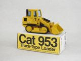 a yellow cat 953 track type loader sitting on a box