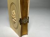 a gold book with a picture of a man and a woman on it