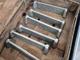 six pieces of wood in a wooden box on the ground