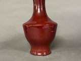 a red vase that is sitting on a table