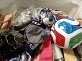 a pile of clothes and a soccer ball on the floor