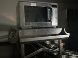 a microwave that is sitting on a table in a kitchen