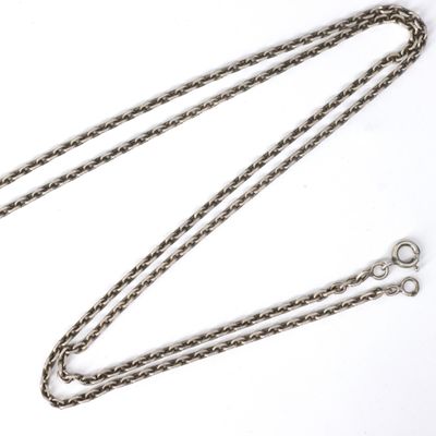 a close up of a chain on a white surface