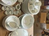 a lot of dishes and cups on the table