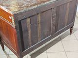 an old wooden cabinet with a marble top on a tiled floor