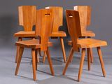 four wooden chairs with one sitting on the other side of the chair