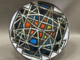a plate with a colorful design on it on a table