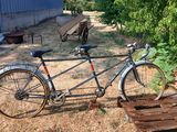 a bike that is parked next to a wooden bench