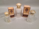 three bottles of perfume sitting next to each other on a table
