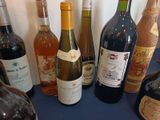 several bottles of wine are lined up on a blue table