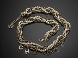 a pearl and gold necklace with the letter h on it
