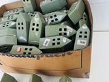 a cardboard box filled with lots of green bricks