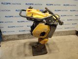 a close up of a machine on a stand in front of a wall