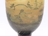 a yellow vase with a black base on a white background