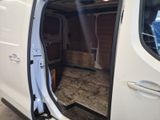 a white van with the door open in a garage