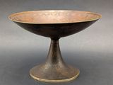 an image of a black and gold bowl sitting on top of a table