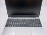 a silver laptop computer sitting on a white surface