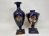 pair of blue vases with gold designs on stands on a white background