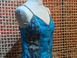 an image of a mannequin with a blue top on a mannequin stand