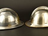 two hard hats that are sitting on a table