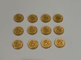a lot of gold coins on a white surface
