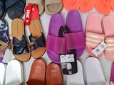 many pairs of sandals that are lined up on a table