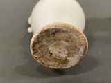 a close up of a white vase on a table
