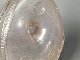 a clear glass bottle with a hole in it