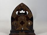 a wooden clock with gears on it sitting on a table