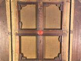 a wooden window with writing on it in a room