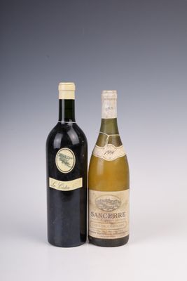 two bottles of wine sitting next to each other on a table
