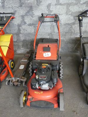 three lawn mowers are lined up in a row next to each other
