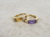 two gold rings with amethorate and diamonds on them