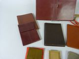 many different types of leather wallets laid out on a table