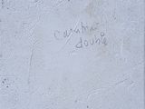 graffiti on the wall of a building with a fire hydrant in front of it