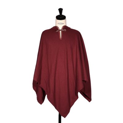 a women ' s burgundy ponche with a white collar and a black top