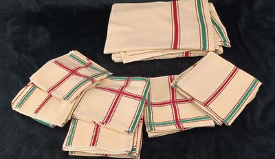 six napkins with red and green stripes on them on a black background