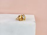 a close up of a gold ring on a marble block