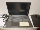 a laptop that is sitting on a desk with a notepad