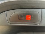 a close up of a red button on a car ' s dashboard