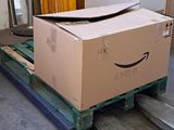 a box on a pallet with a smile drawn on it