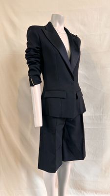 a mannequin wearing a black suit and tie on a mannequin