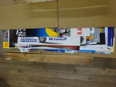 several skis are stacked on top of each other in a room
