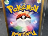 a pokemon card in a clear box on a table