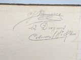 an old book with writing on it sitting on top of a table
