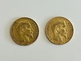 two gold sovereigns, one of which has a head of a man and the other of a woman