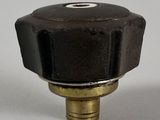 an image of a close up of a black valve on a white surface