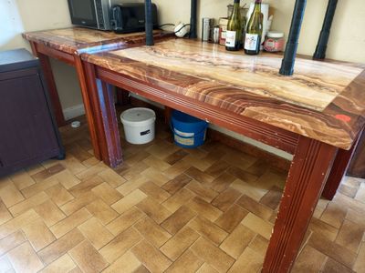 a wooden table with two wine bottles on it