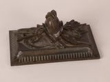 an antique bronze figurine of a frog on a leaf