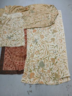 several pieces of fabric are laid out on the floor